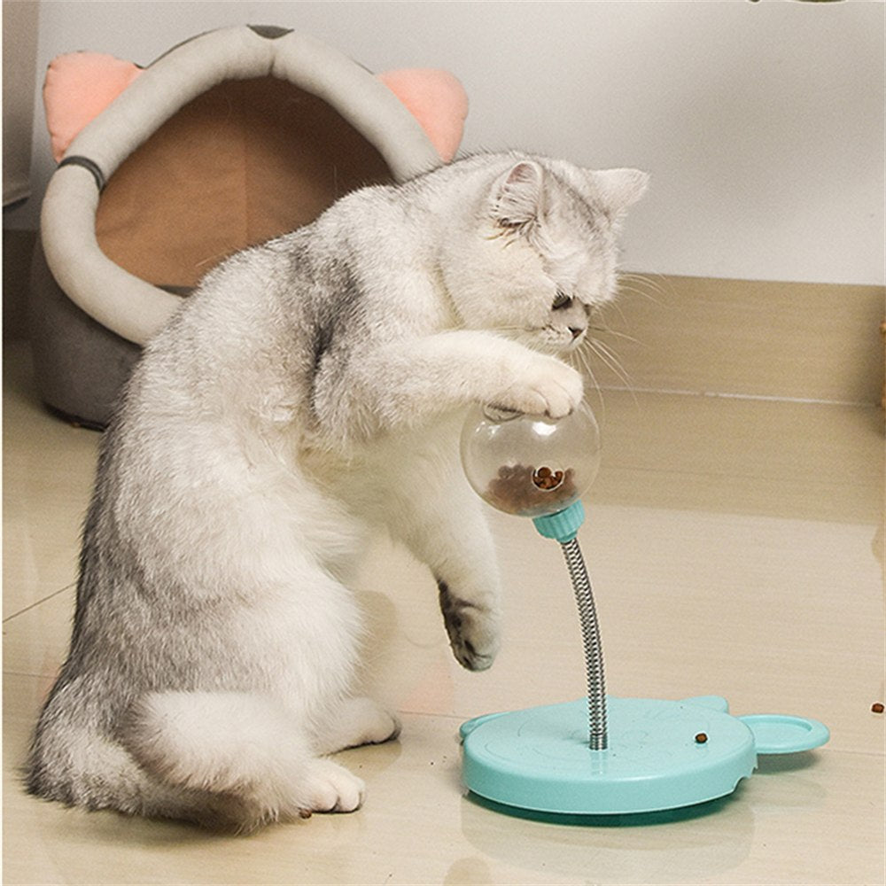 Cat playing with the blue Treat Swing cat feeder toy